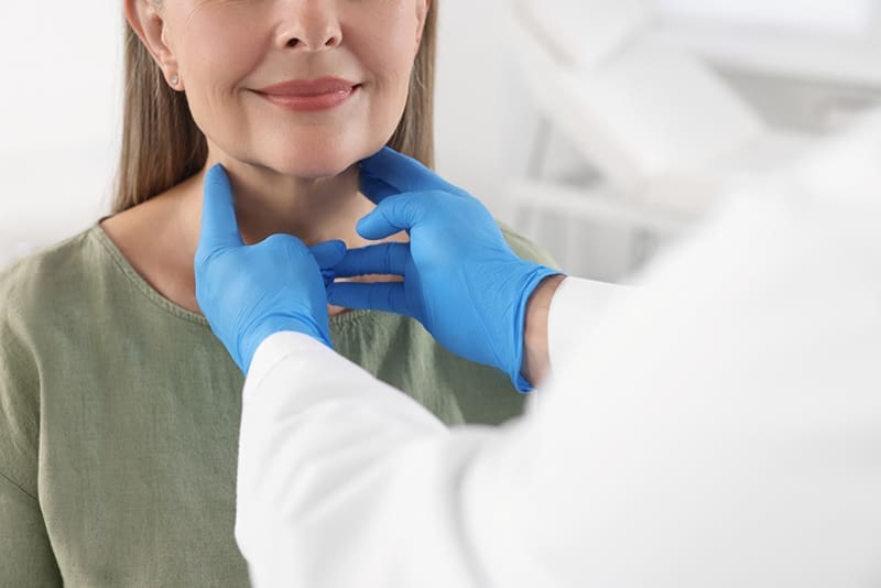 Doctor examines a satisfied patient after a successful RFA procedure of the thyroid.